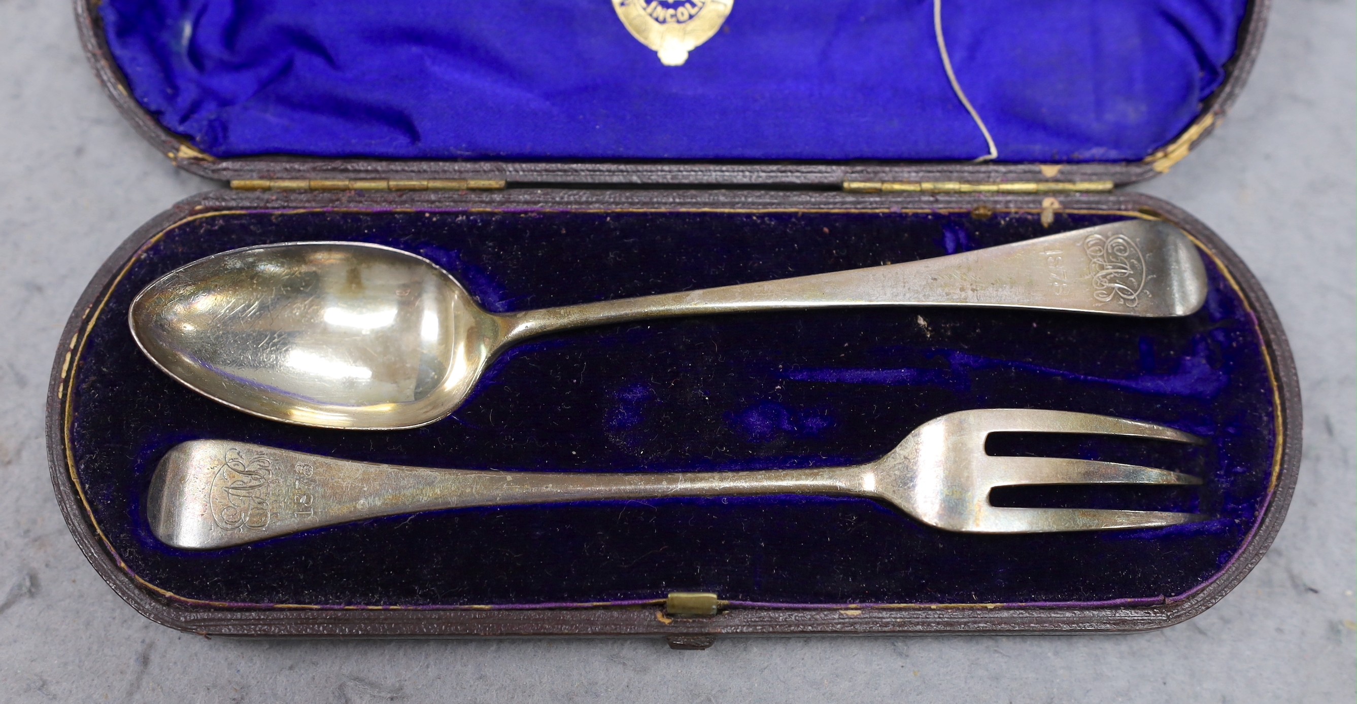 A set of eleven Victorian silver fiddle pattern teaspoons, Elizabeth Eaton, London, 1854/5, assorted other silver teaspoons, various dates and makers, a cased silver christening pair and a silver pocket watch travelling